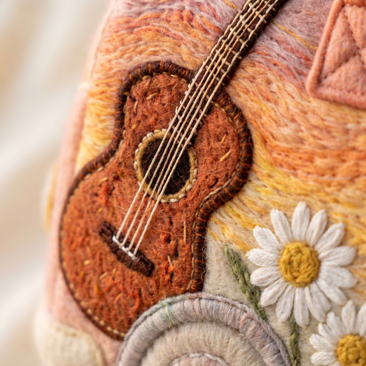 Hippie Bus Weekender — Sunset Strummer — macro detail of embroidered acoustic guitar