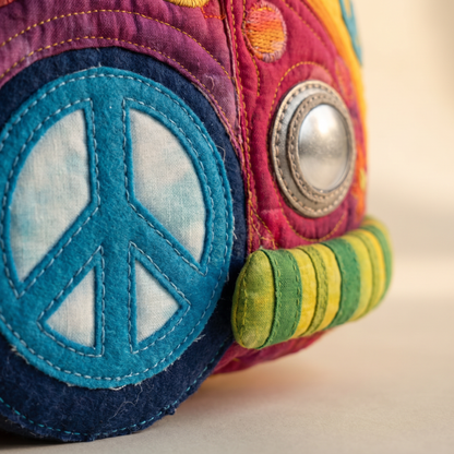 Hippie Bus Weekender — macro detail of the peace-sign wheel and headlight